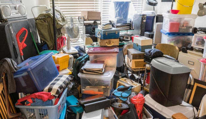 A room filled from floor to ceiling with a severe accumulation of household items A room filled from floor to ceiling with a severe accumulation of household items