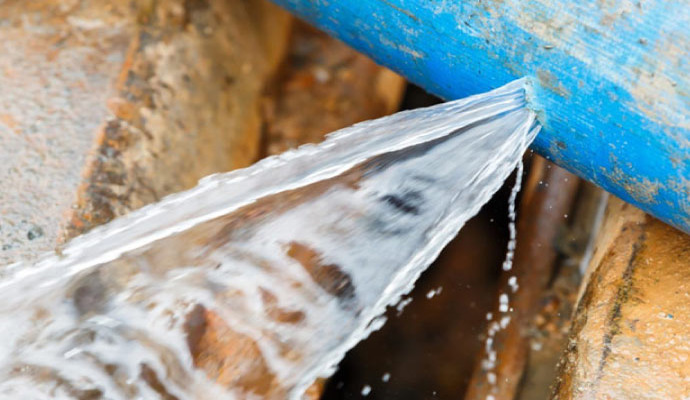Water spilling from a broken pipe causing damage